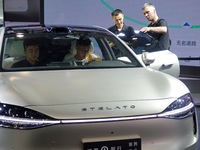 Spectators are looking at the Harmony OS Stelato S9 electric car at the 21st Changchun International Automobile Expo in Changchun, China, on...