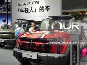 CHANGCHUN, CHINA - JULY 17, 2024 - Spectators view the Chery iCAR 03 electric car at the 21st Changchun International Automobile Expo in Cha...