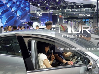 Visitors are visiting BYD's booth at the 21st Changchun International Automobile Expo in Changchun, China, on July 17, 2024. (