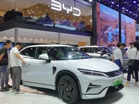 Spectators are looking at BYD Song L electric cars at the 21st Changchun International Automobile Expo in Changchun, Jilin province, China,...