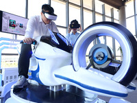 Visitors are experiencing VR motorcycle racing at a VR experience center in Fuzhou, China, on July 17, 2024. (