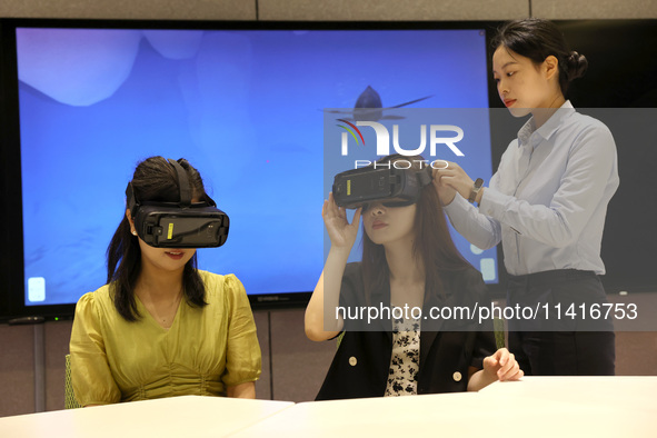 Visitors are experiencing a VR project at a VR Experience center in Fuzhou, Fujian province, China, on July 17, 2024. 