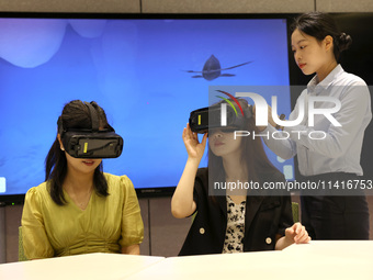 Visitors are experiencing a VR project at a VR Experience center in Fuzhou, Fujian province, China, on July 17, 2024. (