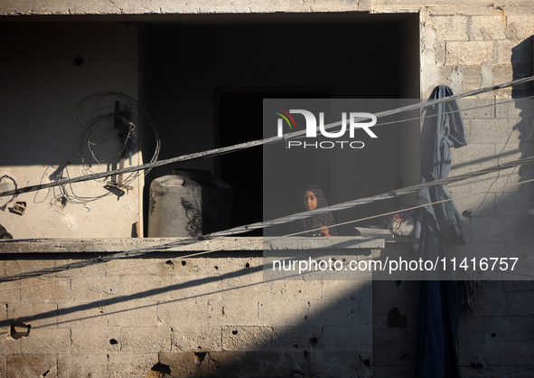 Palestinians are inspecting a house destroyed in an Israeli strike, amid the Israel-Hamas conflict, in Al-Zawaida, central Gaza Strip, on Ju...