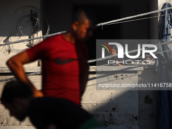 Palestinians are inspecting a house destroyed in an Israeli strike, amid the Israel-Hamas conflict, in Al-Zawaida, central Gaza Strip, on Ju...