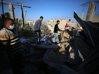 Palestinians are inspecting a house destroyed in an Israeli strike, amid the Israel-Hamas conflict, in Al-Zawaida, central Gaza Strip, on Ju...