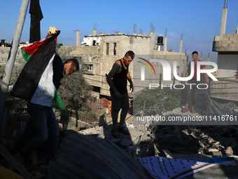 Palestinians are inspecting a house destroyed in an Israeli strike, amid the Israel-Hamas conflict, in Al-Zawaida, central Gaza Strip, on Ju...