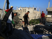 Palestinians are inspecting a house destroyed in an Israeli strike, amid the Israel-Hamas conflict, in Al-Zawaida, central Gaza Strip, on Ju...