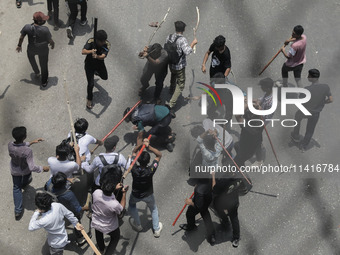 Anti-quota protestors are beating a police officer in Dhaka, Bangladesh, on July 18, 2024. (