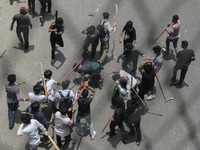 Anti-quota protestors are beating a police officer in Dhaka, Bangladesh, on July 18, 2024. (