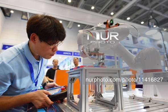 A technician is debuting a collaborative robot at the 26th China Qingdao International Industrial Automation Technology and Equipment Exhibi...