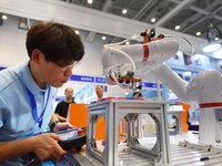 A technician is debuting a collaborative robot at the 26th China Qingdao International Industrial Automation Technology and Equipment Exhibi...