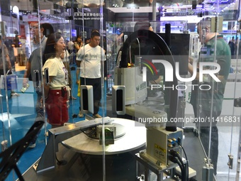 Participants are looking at an AI dynamic visual grasping unit display at the 26th China Qingdao International Industrial Automation Technol...