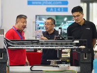 Participants are looking at a drive system displayed by a company at the 26th China Qingdao International Industrial Automation Technology a...