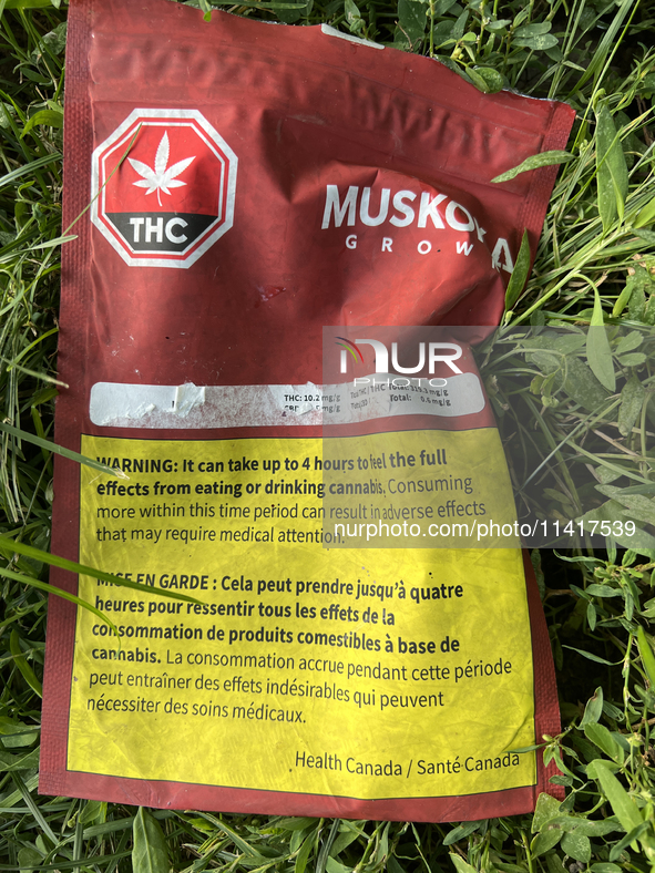 A discarded package from an edible cannabis product is lying on the ground near a playground in Toronto, Ontario, Canada, on July 16, 2024. 