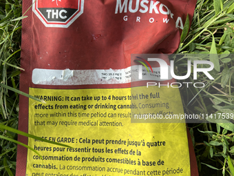 A discarded package from an edible cannabis product is lying on the ground near a playground in Toronto, Ontario, Canada, on July 16, 2024....