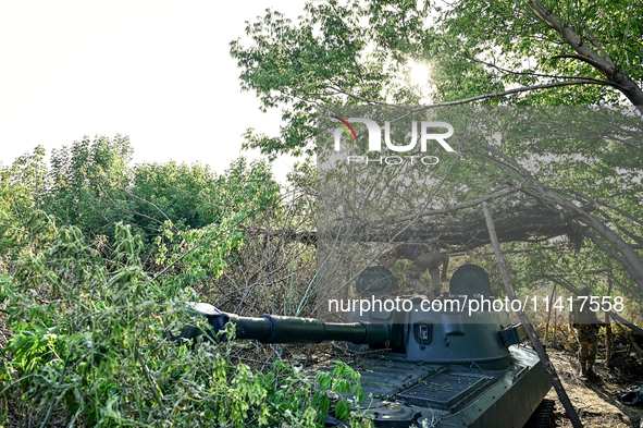 Servicemen of the 24th King Danylo Separate Mechanized Brigade are staying by a military vehicle at combat positions near Chasiv Yar, Bakhmu...