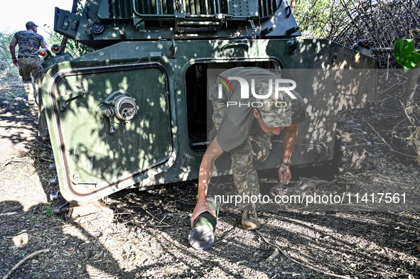 A serviceman of the 24th King Danylo Separate Mechanized Brigade is getting out of a military vehicle at combat positions near Chasiv Yar, B...