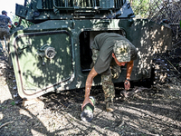 A serviceman of the 24th King Danylo Separate Mechanized Brigade is getting out of a military vehicle at combat positions near Chasiv Yar, B...