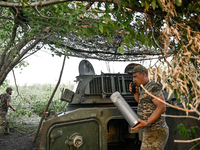 Andrii, a commander of an artillery crew of the 24th King Danylo Separate Mechanized Brigade, is using a handheld transceiver during a comba...