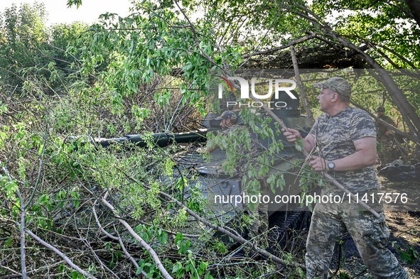 Servicemen of the 24th King Danylo Separate Mechanized Brigade are staying by a military vehicle at combat positions near Chasiv Yar, Bakhmu...