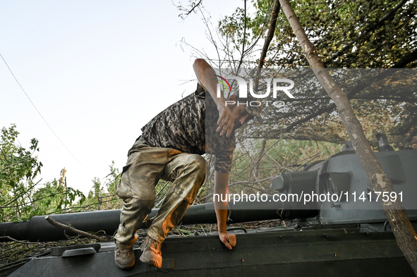 A serviceman of the 24th King Danylo Separate Mechanized Brigade is jumping off a military vehicle during a combat mission near Chasiv Yar,...