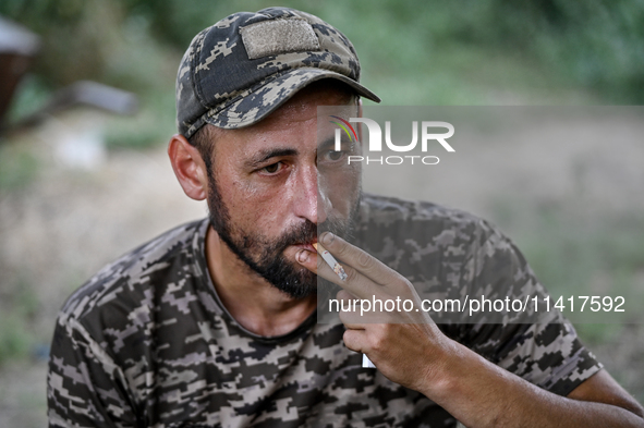 A serviceman of the 24th King Danylo Separate Mechanized Brigade is smoking a cigarette in Bakhmut district, Donetsk region, eastern Ukraine...