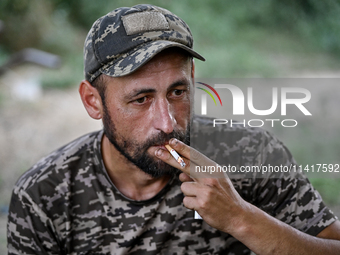 A serviceman of the 24th King Danylo Separate Mechanized Brigade is smoking a cigarette in Bakhmut district, Donetsk region, eastern Ukraine...