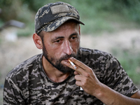 A serviceman of the 24th King Danylo Separate Mechanized Brigade is smoking a cigarette in Bakhmut district, Donetsk region, eastern Ukraine...