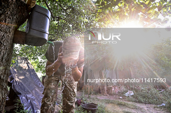 A serviceman of the 24th King Danylo Separate Mechanized Brigade is washing his face at combat positions near Chasiv Yar, Bakhmut district,...