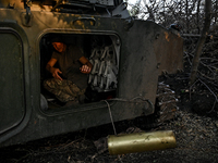 A serviceman of the 24th King Danylo Separate Mechanized Brigade is in the cabin of a 122-mm howitzer D-30 during a combat mission near Chas...