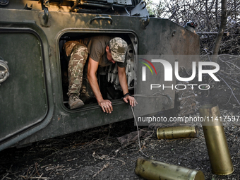 A serviceman of the 24th King Danylo Separate Mechanized Brigade is getting out of the cabin of a 122-mm howitzer D-30 during a combat missi...