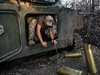 A serviceman of the 24th King Danylo Separate Mechanized Brigade is getting out of the cabin of a 122-mm howitzer D-30 during a combat missi...