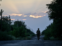 A serviceman of the 24th King Danylo Separate Mechanized Brigade is walking along a road in Bakhmut district, Donetsk region, eastern Ukrain...