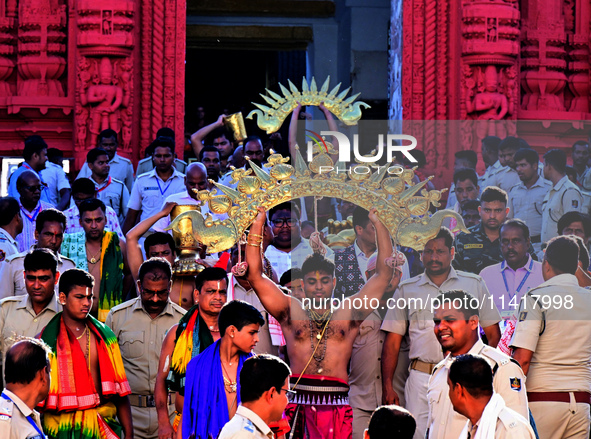 Temple servitors are carrying gold ornaments of temple deities before making the golden dressed ceremony 'Suna Besha' atop their chariots be...