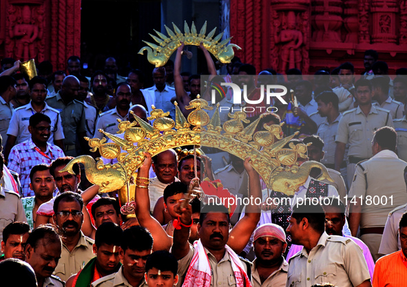 Temple servitors are carrying gold ornaments of temple deities before making the golden dressed ceremony 'Suna Besha' atop their chariots be...