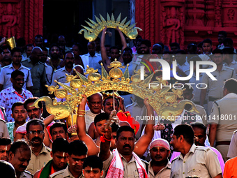 Temple servitors are carrying gold ornaments of temple deities before making the golden dressed ceremony 'Suna Besha' atop their chariots be...