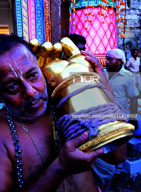 Temple servitors are carrying gold ornaments of temple deities before making the golden dressed ceremony 'Suna Besha' atop their chariots be...