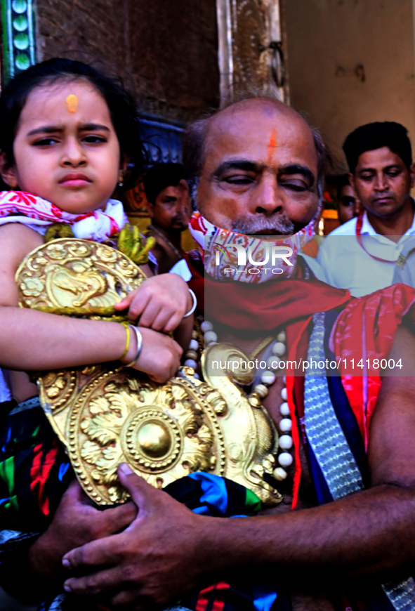 Temple servitors are carrying gold ornaments of temple deities before making the golden dressed ceremony 'Suna Besha' atop their chariots be...