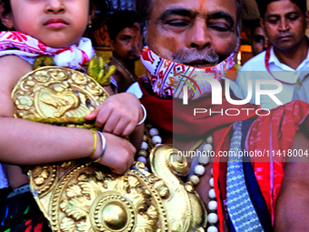 Temple servitors are carrying gold ornaments of temple deities before making the golden dressed ceremony 'Suna Besha' atop their chariots be...