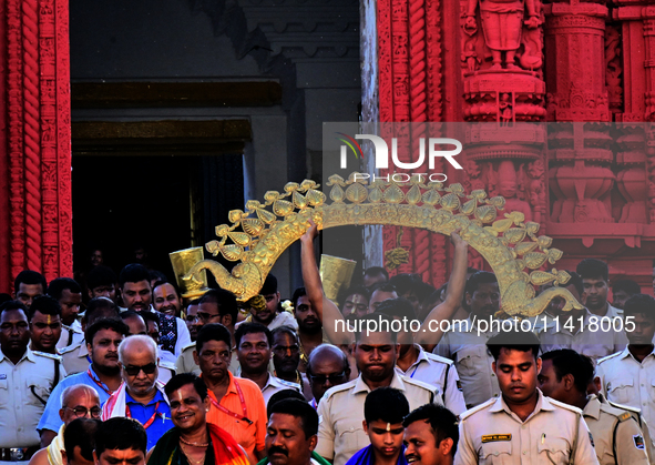 Temple servitors are carrying gold ornaments of temple deities before making the golden dressed ceremony 'Suna Besha' atop their chariots be...