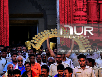 Temple servitors are carrying gold ornaments of temple deities before making the golden dressed ceremony 'Suna Besha' atop their chariots be...