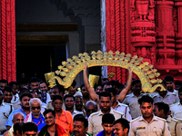 Temple servitors are carrying gold ornaments of temple deities before making the golden dressed ceremony 'Suna Besha' atop their chariots be...