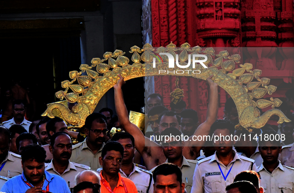 Temple servitors are carrying gold ornaments of temple deities before making the golden dressed ceremony 'Suna Besha' atop their chariots be...