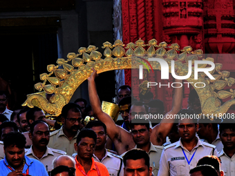 Temple servitors are carrying gold ornaments of temple deities before making the golden dressed ceremony 'Suna Besha' atop their chariots be...