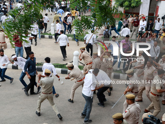 Police personnel are lathicharging the agitators during a protest by various student organizations demanding the conduct of Rajasthan Univer...