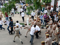 Police personnel are lathicharging the agitators during a protest by various student organizations demanding the conduct of Rajasthan Univer...