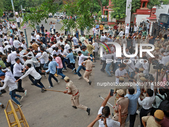 Police personnel are lathicharging the agitators during a protest by various student organizations demanding the conduct of Rajasthan Univer...