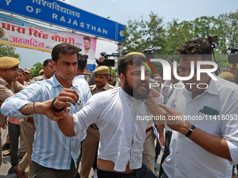 Police personnel are arresting the agitators during a protest by various student organizations demanding the conduct of Rajasthan University...