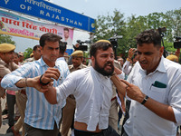 Police personnel are arresting the agitators during a protest by various student organizations demanding the conduct of Rajasthan University...